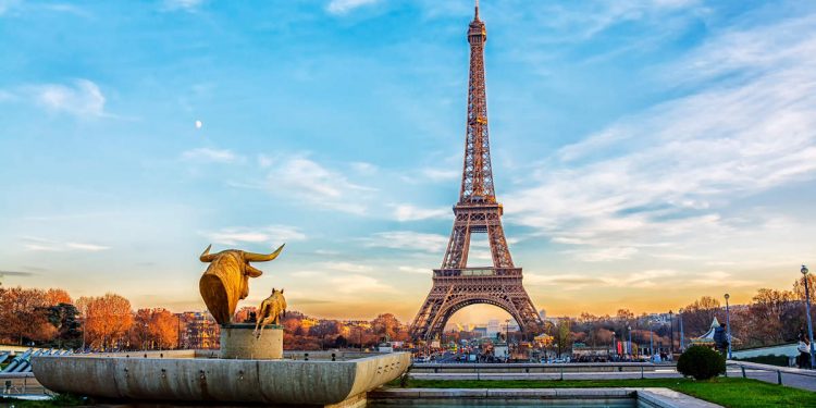 Eiffel Tower at sunset in Paris, France. Romantic travel background