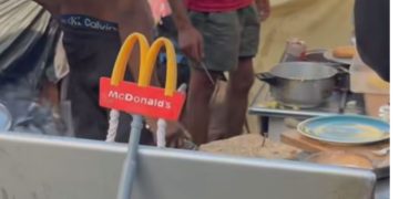 Los migrantes asentados en la playa del Trampolín crean su propio «McDonald’s» en un poblado improvisado